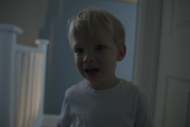 Blonde toddler boy walks from room to room in house