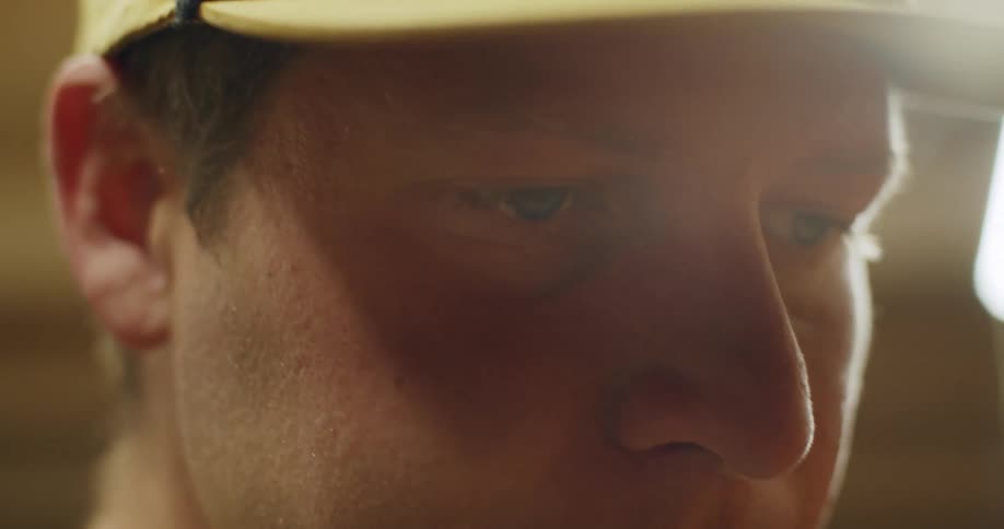 The eyes of a man wearing a cap and looking determined