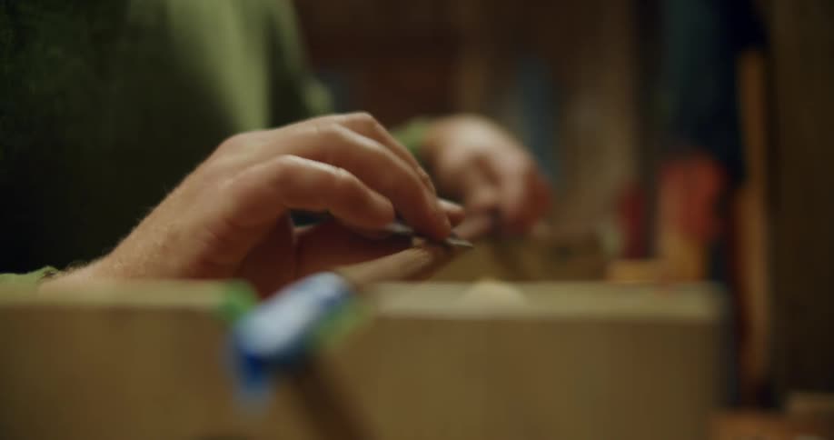 Man with green sweatshirt polishes golf club