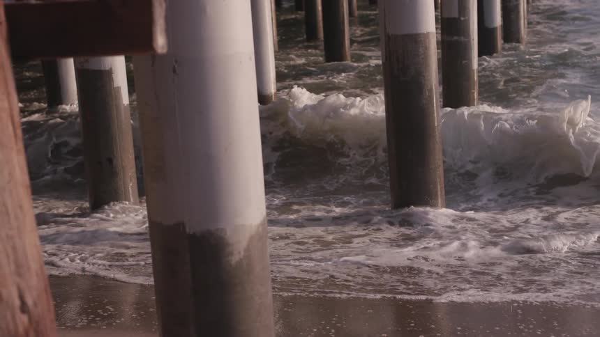Waves are crashing against the shore