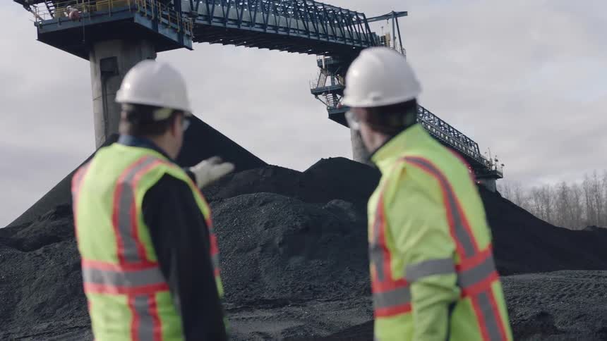 Two people point out towards a construction site