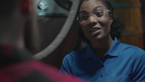A woman wearing goggles is talking to someone