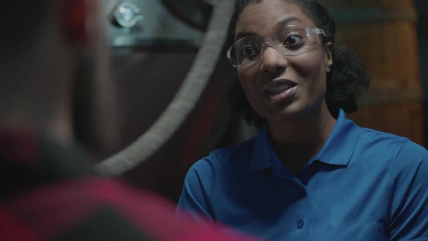 A woman wearing goggles is talking to someone