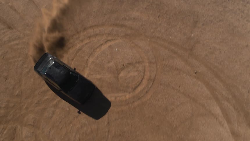 Car doing donuts in the dirt