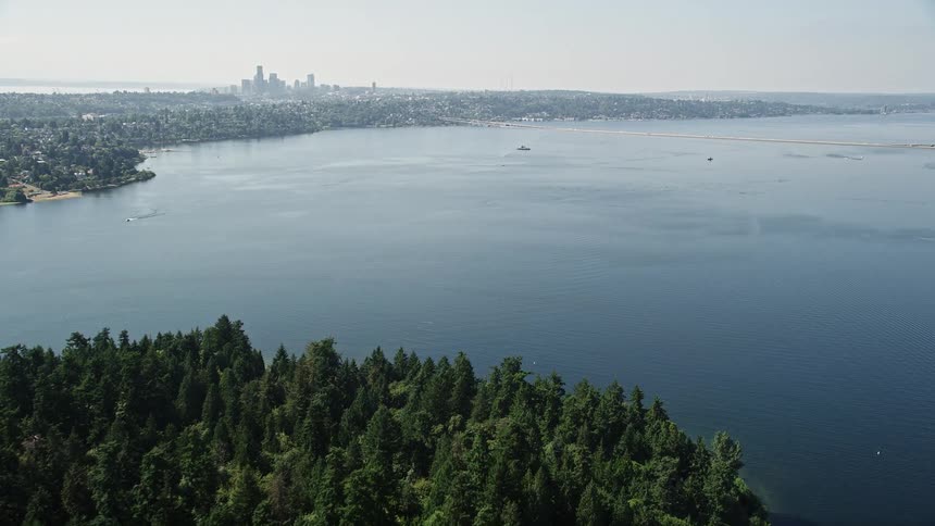  aerial footage of a sunny day in Seattle Washington showcasing the breathtaking Downtown skyline Lake Washington and the approach to the bridge