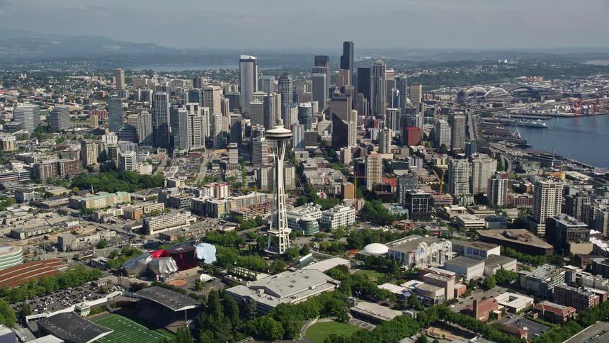 A stunning aerial view of the Space Needle and downtown skyscrapers in the vibrant city of Seattle Washington during a sunny day