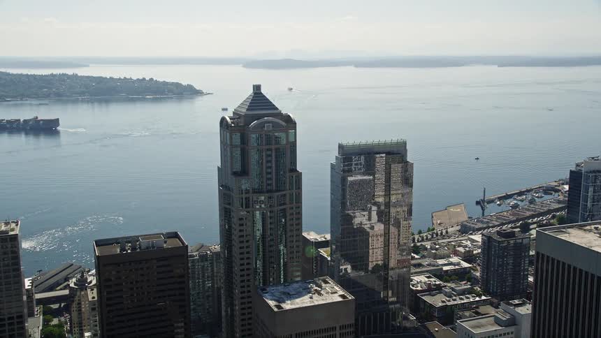 an aerial view of downtown Seattle's Central Waterfront revealing the stunning skyscrapers and bustling city below all captured during a sunny day in the Pacific Northwest