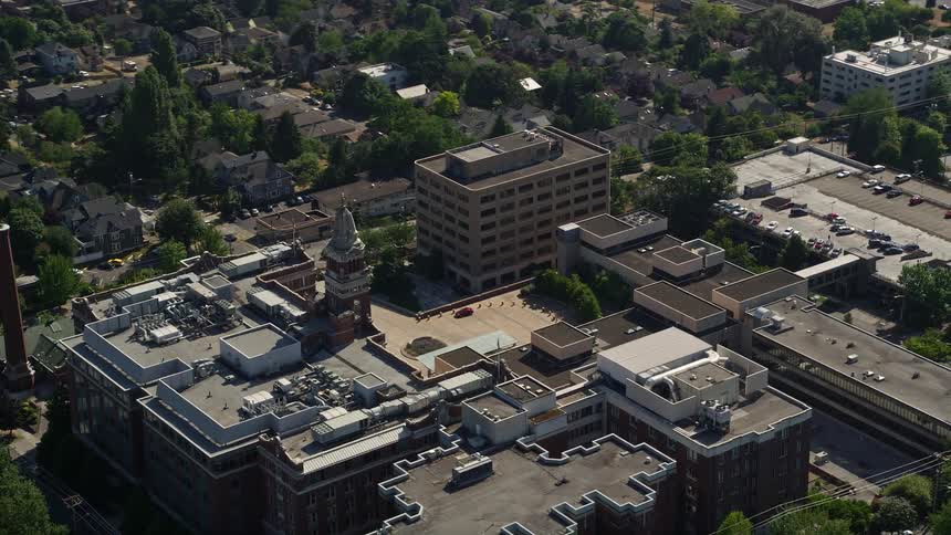 Aerial footage showcasing the Swedish Medical Center hospital in Central Seattle Washington on a sunny day with an overhead orbit view