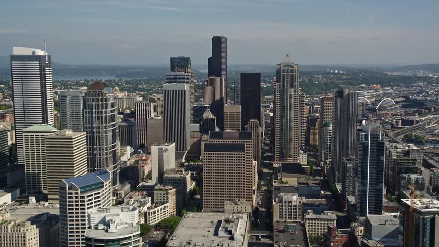 A stunning aerial view of downtown Seattle Washington showcasing the city's impressive skyline filled with skyscrapers and high-rises on a sunny day