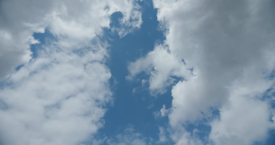 Fluffy clouds fill the sky on a sunny day