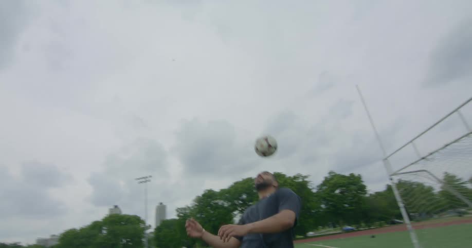A soccer player using his head to play with the ball
