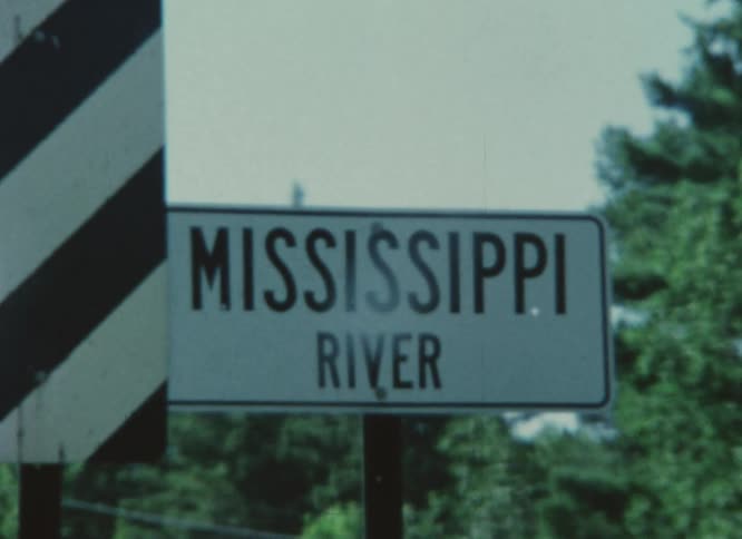 A street signs identifies a river crossing
