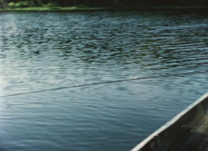 Grandfather fishes with two boys in same boat