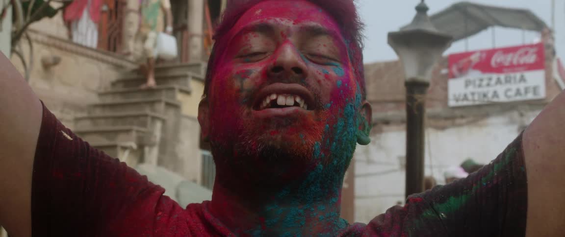 A man at a festival with paint