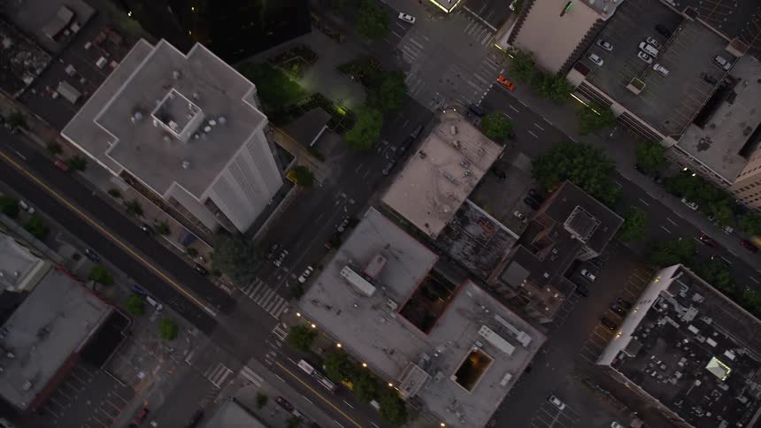 an sunset view of Downtown Seattle's bustling city streets and office buildings from a bird's eye perspective