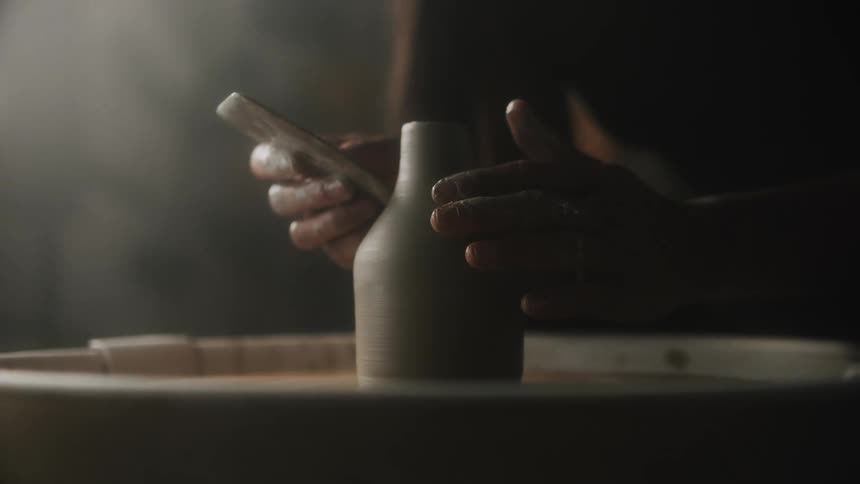 A person is sculpting clay