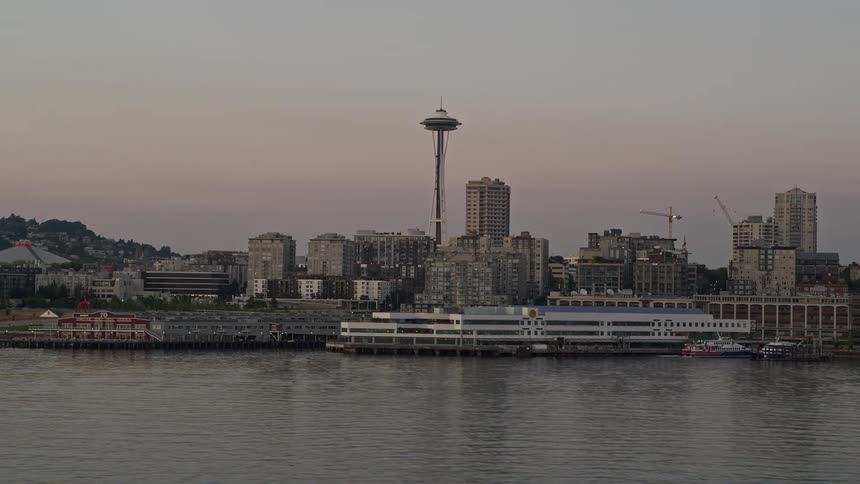 A stunning aerial view of the Seattle Space Needle and Waterfront piers at sunset showcasing the iconic landmarks of Downtown Seattle Washington