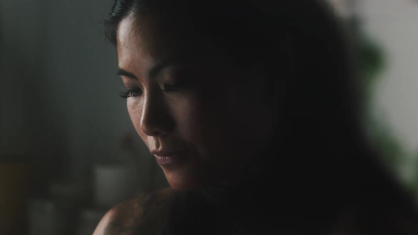 Close up of the face of a young attractive woman working at home