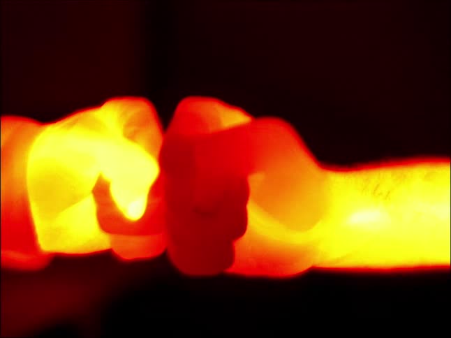 Thermal imagery close up of a couple of people fist bumping