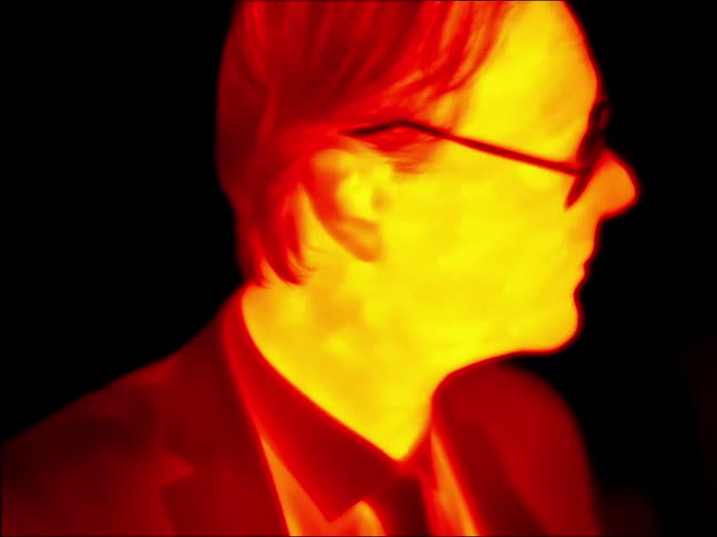 A man puts on sunglasses through an infrared light