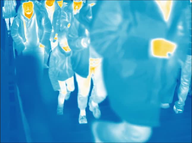 A large crowd walks up and down stairs in a city