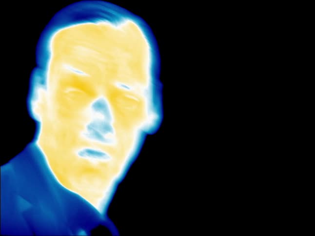 A man filmed in infrared moves around