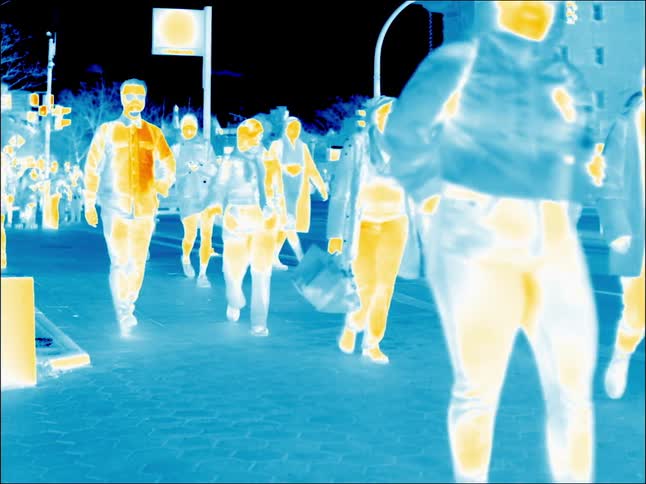 The view is of people walking outdoors around the city area