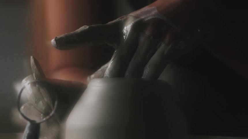 A person is sculpting clay
