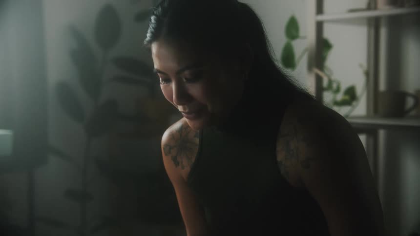 A woman is sculpting pottery in her house