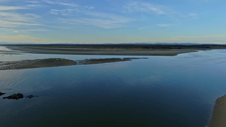 Aerial view of beach and ocean at dusk