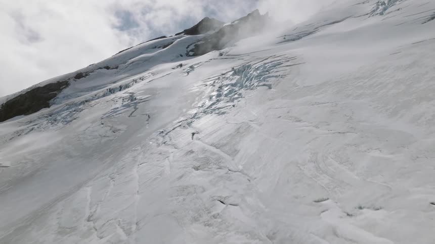 Aerial view of rugged glacier on snowy mountain slope
