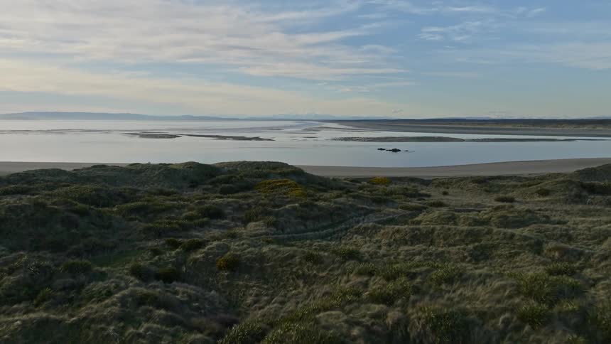 Aerial view of a landscape next to the ocean is displayed