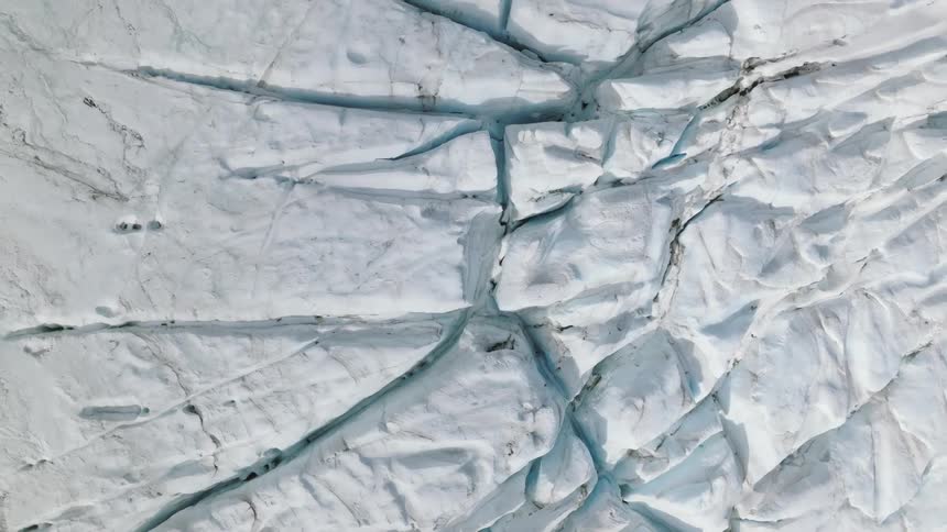 Blue shows in crevices of glacier
