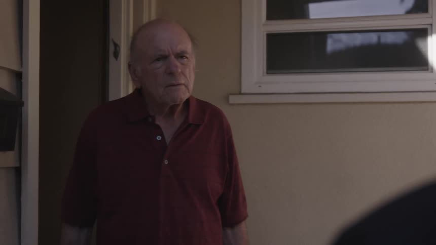 A man steps outside his house to confront a man waiting