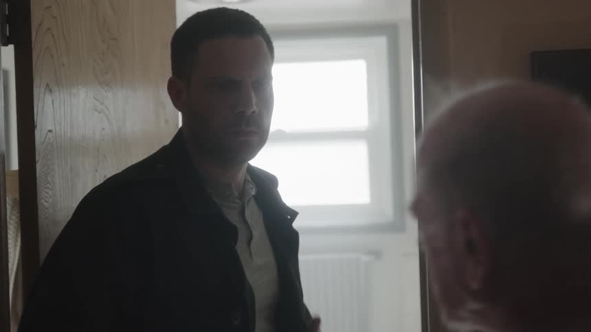 A man throws his jacket at an elderly man during an argument at home