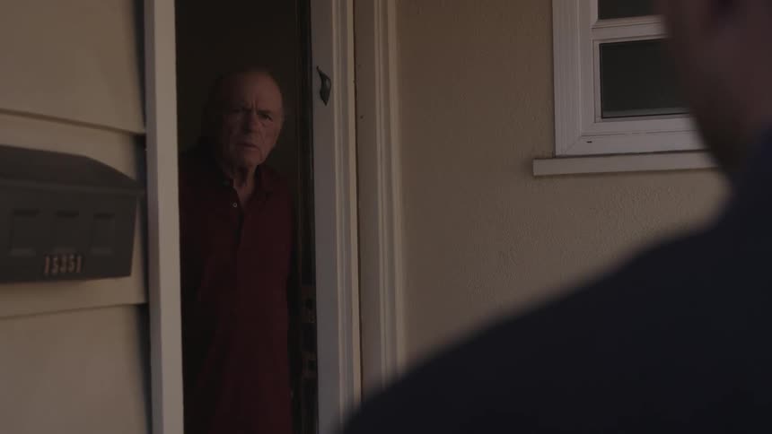 An older man looking shocked and disappointed gazes at the person approaching him