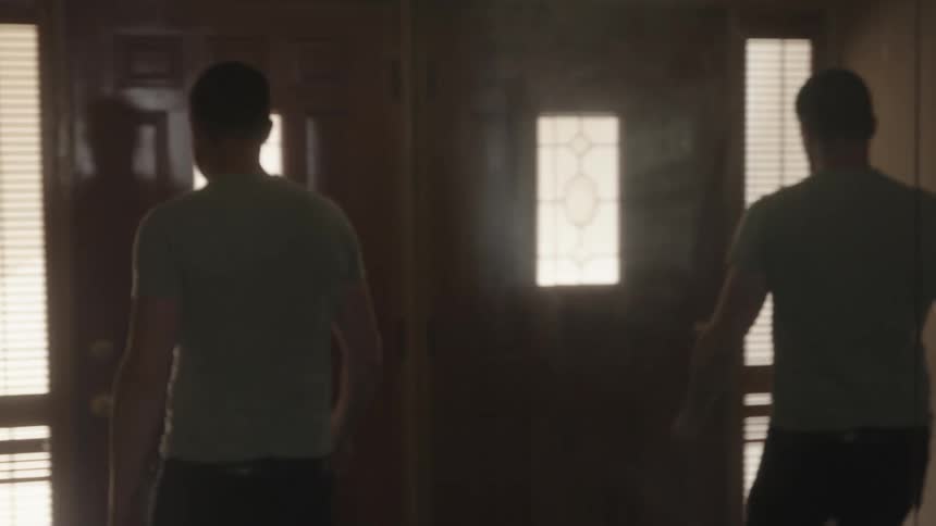 Reflection of a man walking out of his house