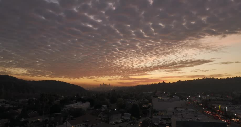 Aerial view of distant skyscrapers and buildings in the city at dusk