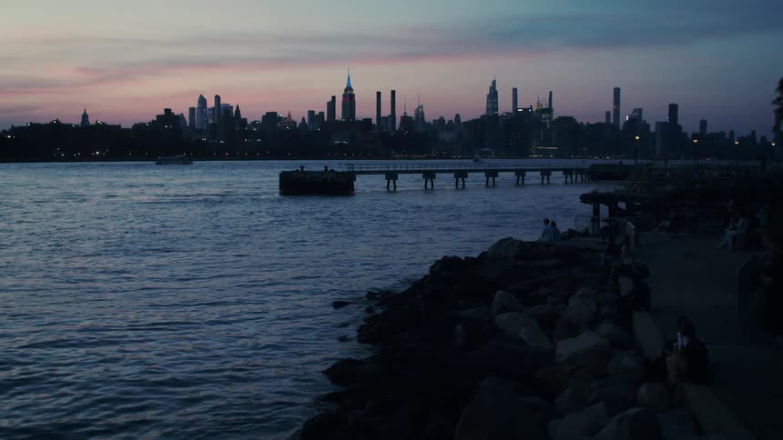 Landscape of city skyline seen from the coast at dusk