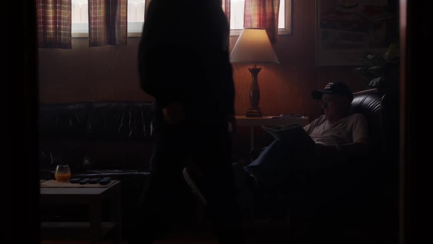 Two men are sitting on a couch and talking