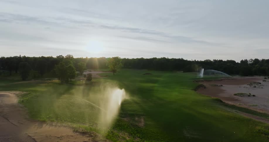 Aerial view of golf course at sunset