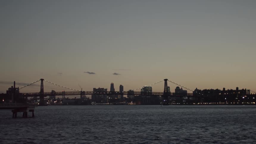 A bridge and city skyline after sunset
