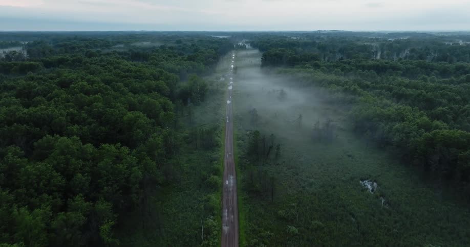 Aerial view of a road in the wilderness is displayed