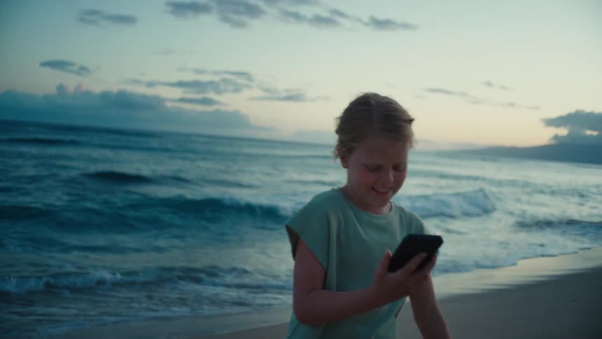 A girl standing out at the ocean
