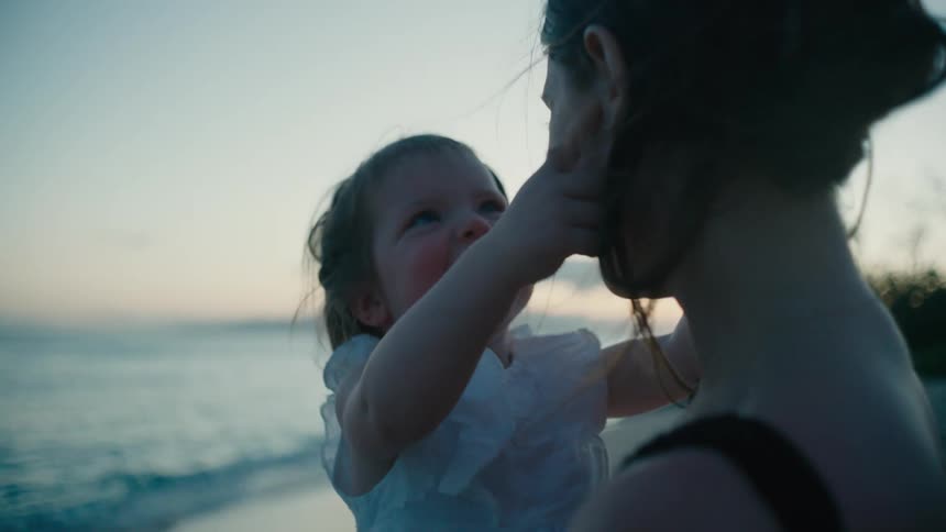 The view is of a portrait of a mother and baby at the beach