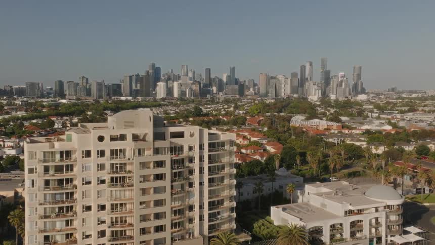 Aerial view of apartment building and distant urban skyline in the city