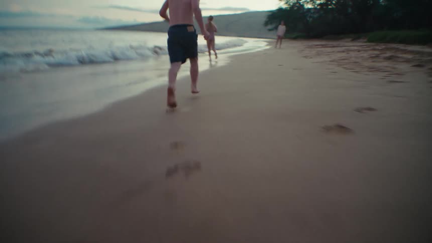 Kids run across beach to waiting mother
