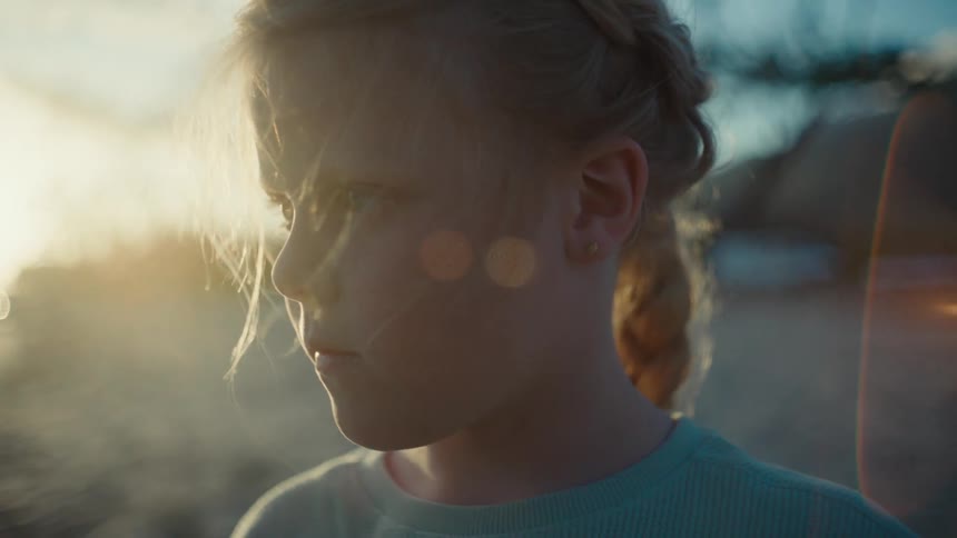 The view is of a portrait of a child that is on the beach