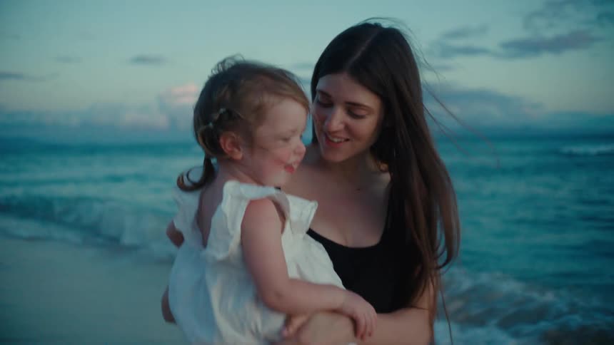 The view is of a portrait of a mother and kid at the beach