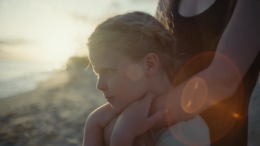 Girls hug on the beach